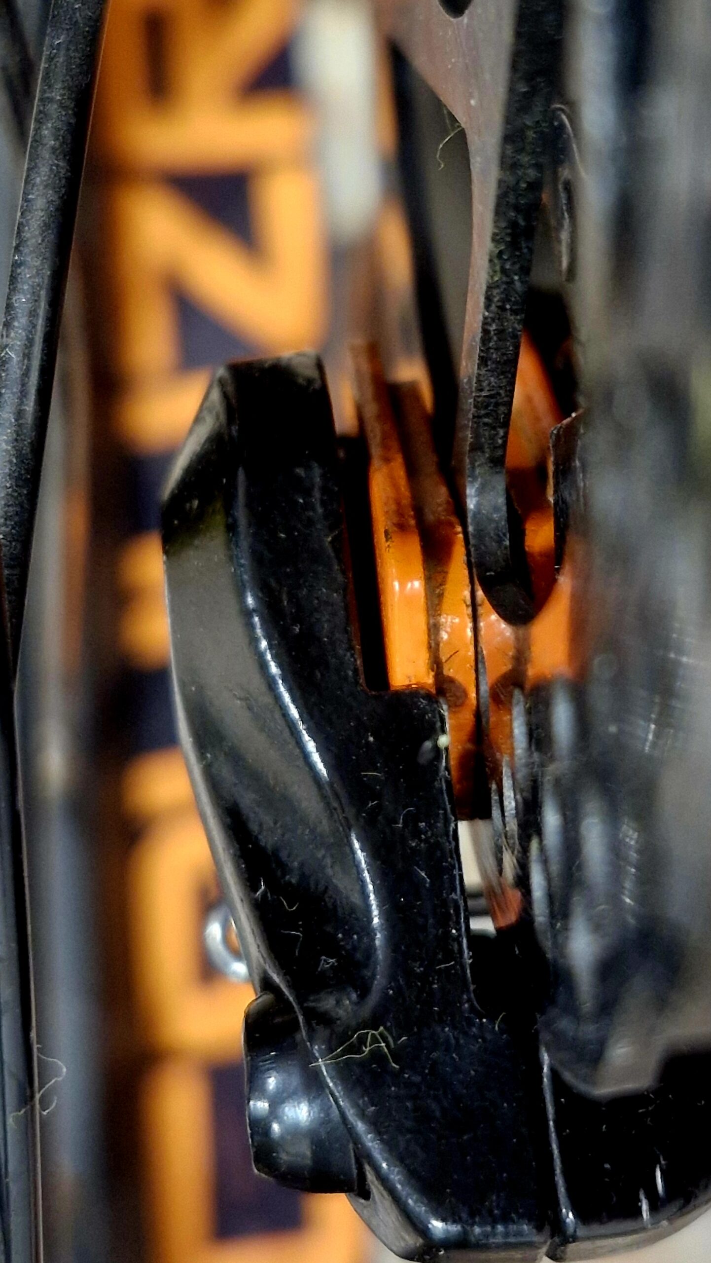 Close-up of a bicycle disc brake with orange CRUUZR details